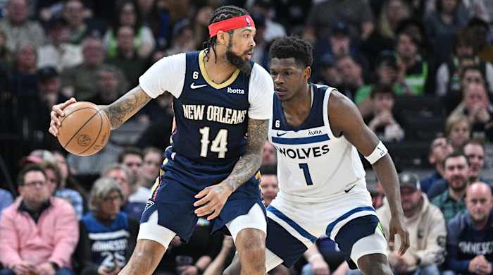 Pelicans forward Brandon Ingram (14) controls the ball as Timberwolves guard Anthony Edwards (1) defends during the last game of the 2022-23 regular season